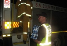 Global-Pumps-water-bottles-being-distributed-to-firefighters-by-volunteers-